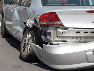 A damaged silver car after an accident